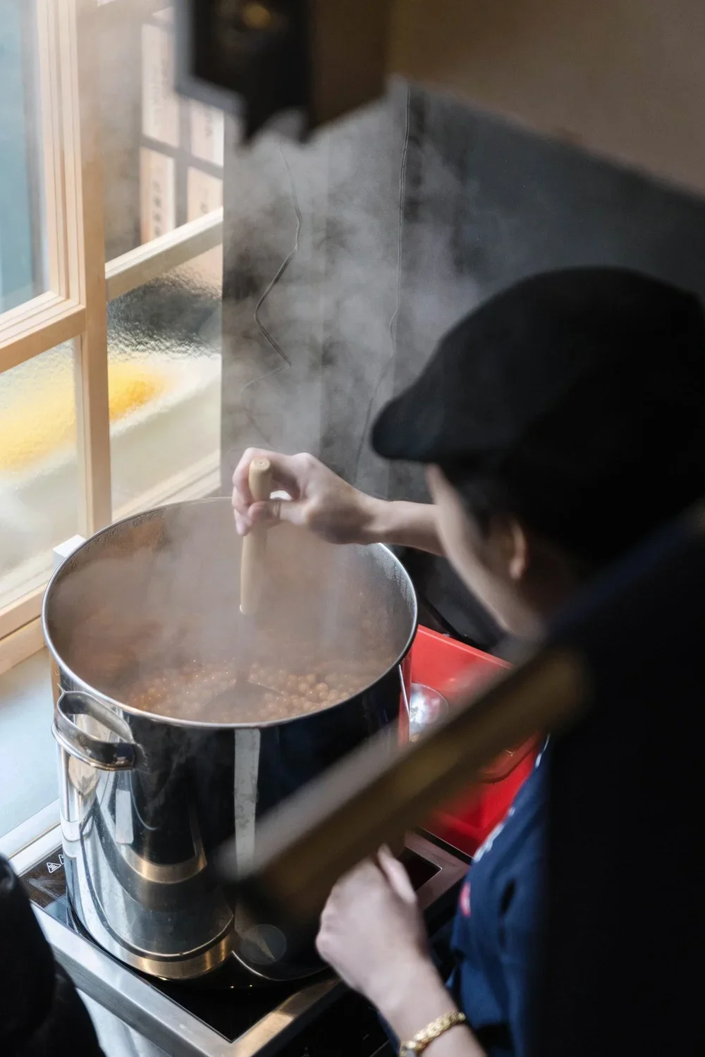 tapioca balls being stirred in a large pot at yi fang taiwan fruit tea in tokyo japan