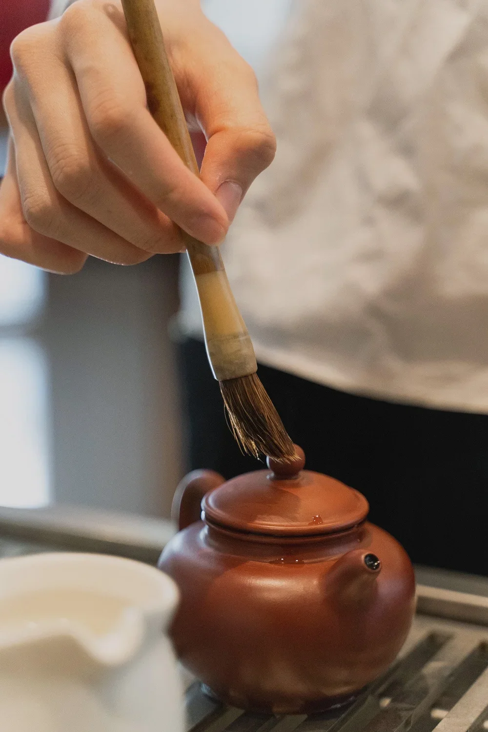 brush on brown ceramic teapot