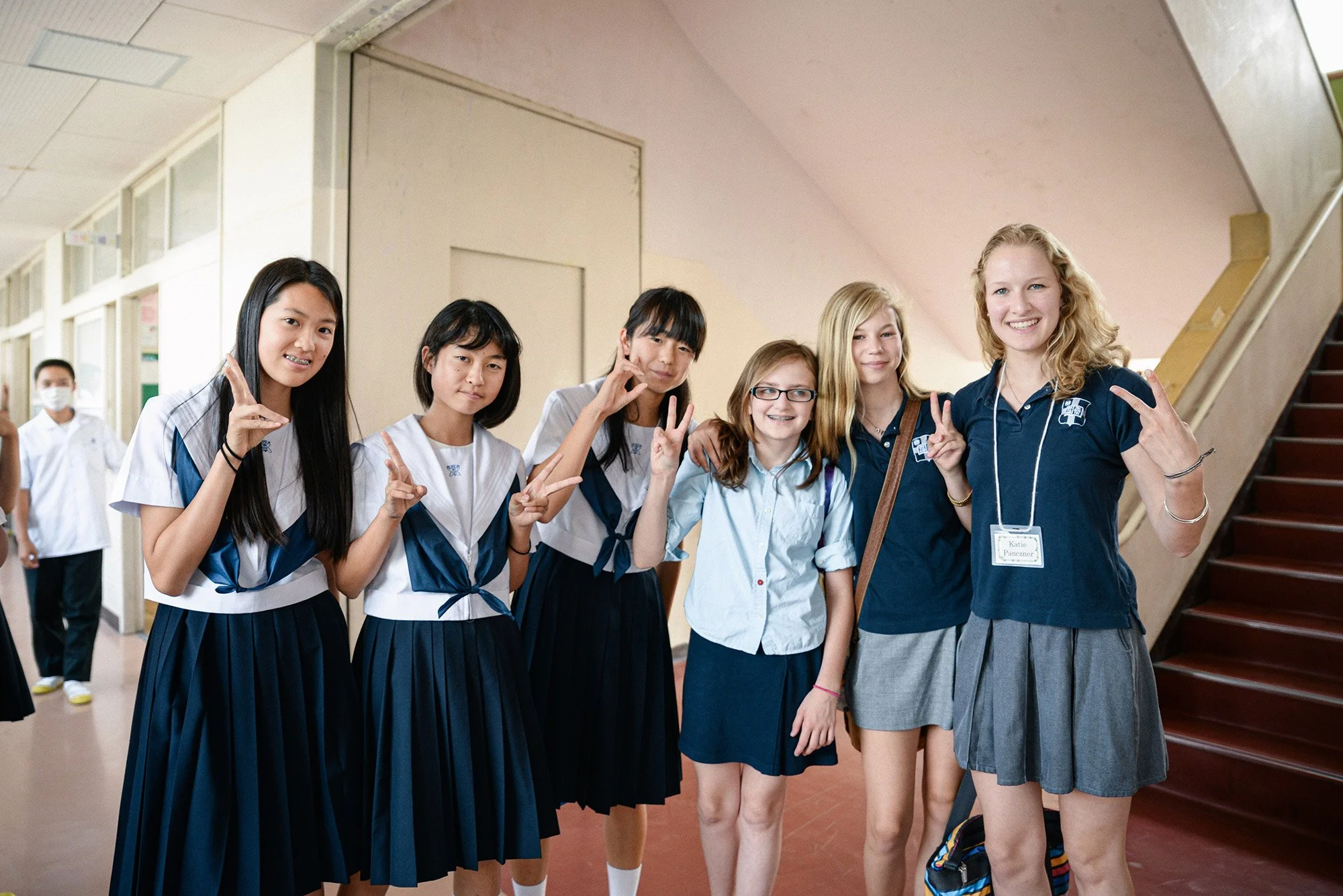 American and Japanese junior high school students smiling together at school in Japan