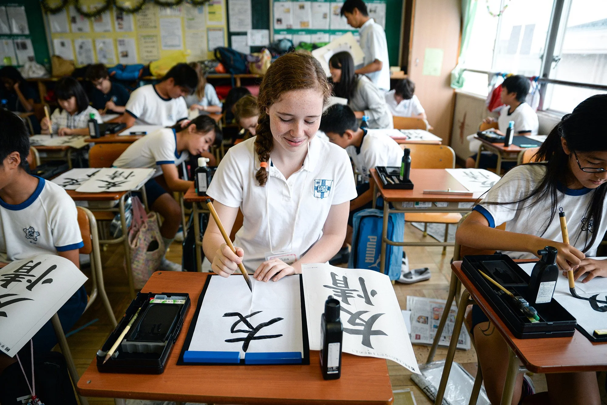 An American student learning calligraphy at a school in Japan