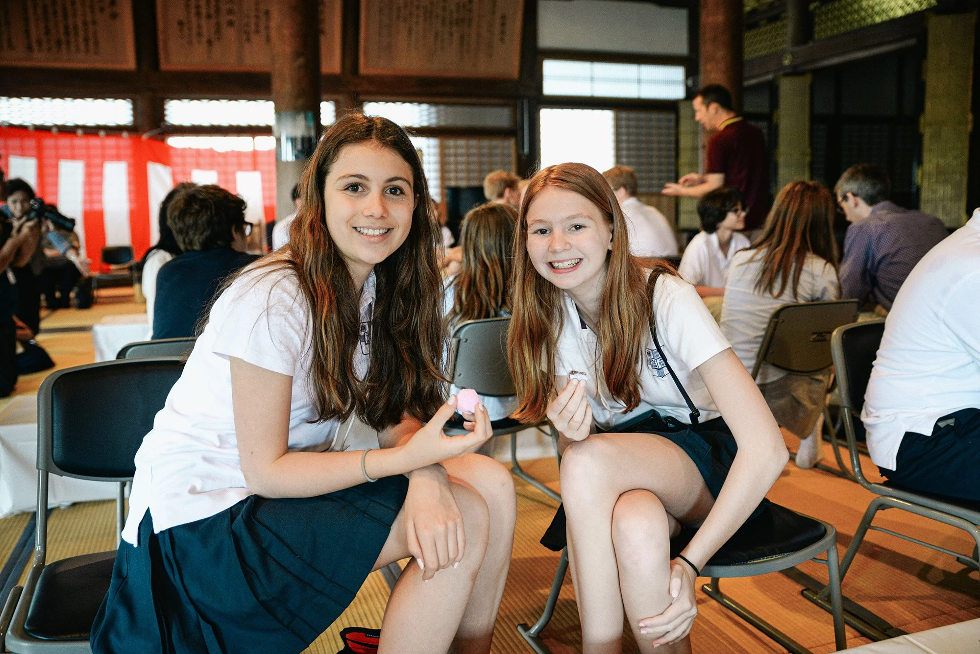 Two American students smiling in a temple in Japan