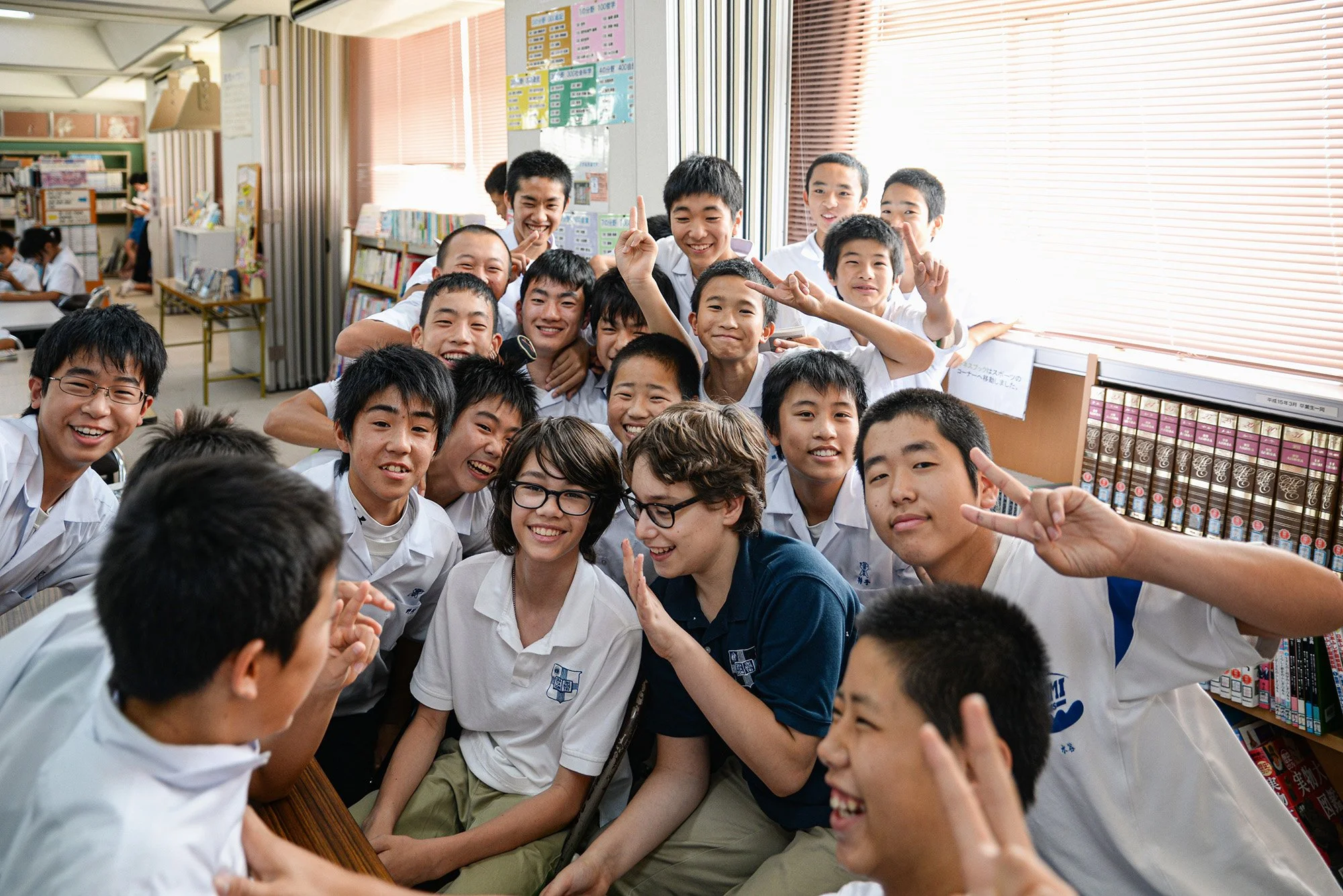 American and Japanese junior high school students smiling together at school in Japan