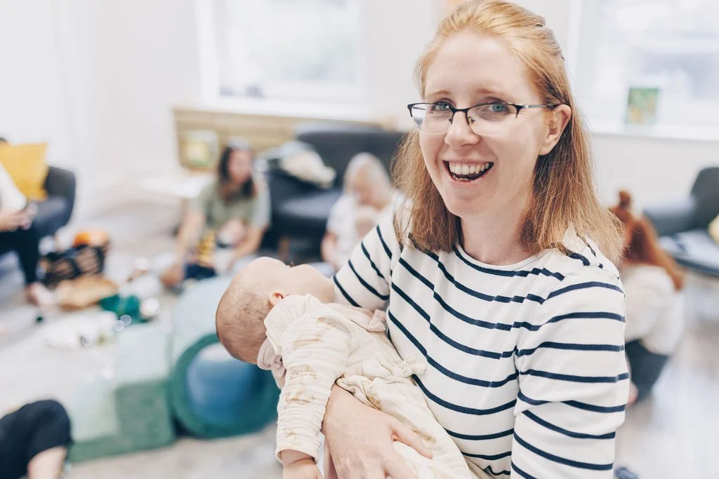 Gemma Kitto the birth doula from born to birth cornwall holds a baby at the nest while she waits for her pregnant client to go into labour
