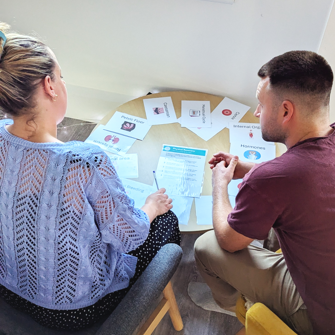 a pregnant woman and her birth partner explore postpartum recovery at a birth preparation workshop in Truro with Borntobirthcornwall