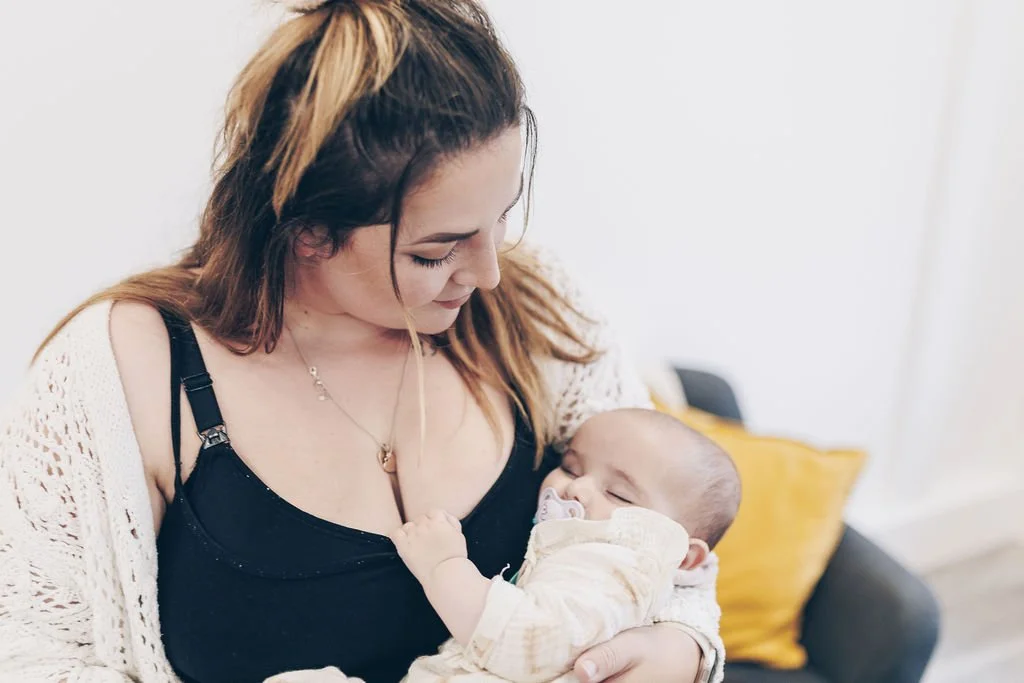 A new mum reflects on her birth experience as she holds her baby