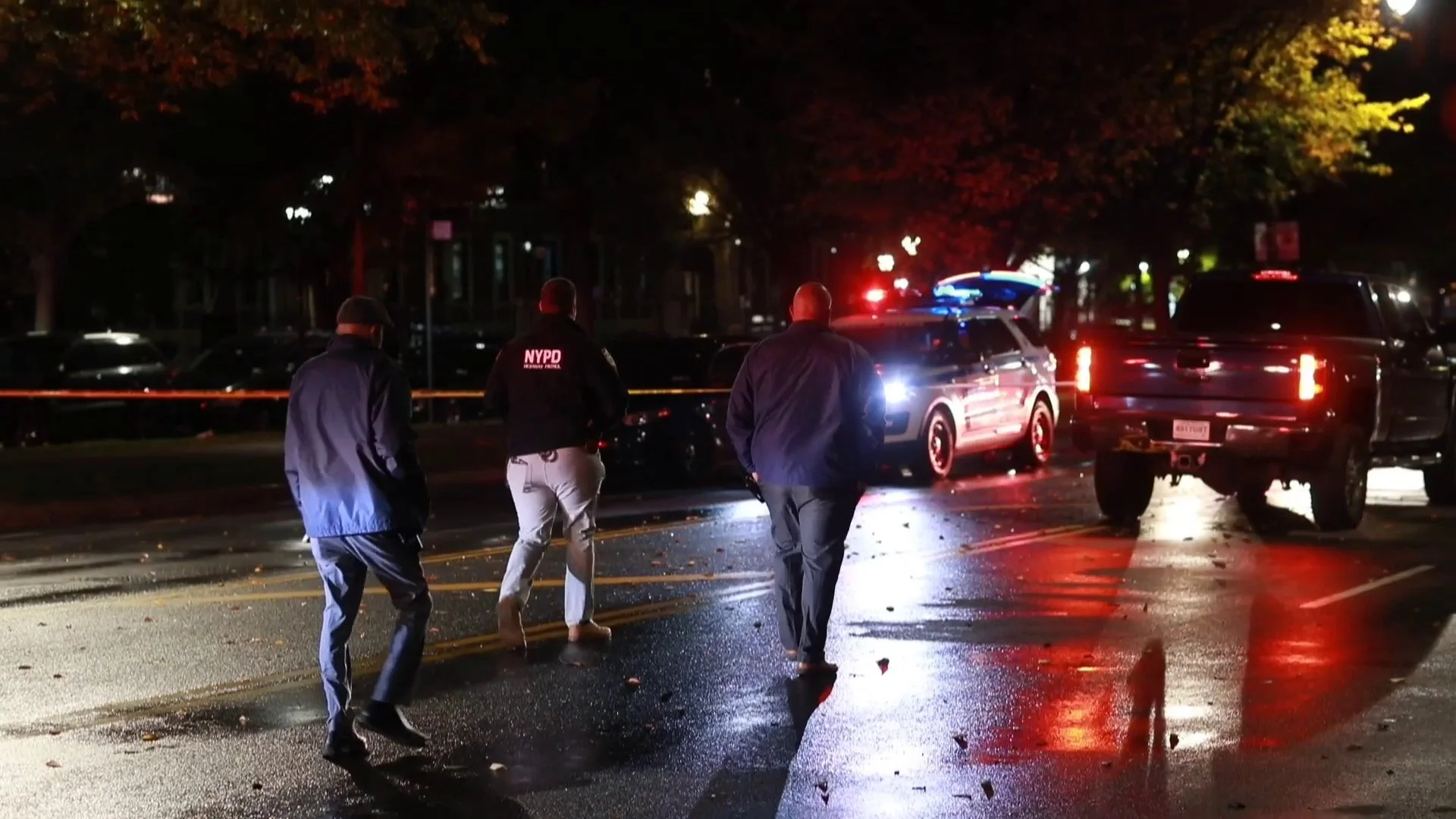 Investigators walking down Eastern Parkway in Brooklyn in October 2022, on the scene of the fatal car crash that killed Walter Gonzalez. A truck with a New Jersey temporary license plate is in the background.