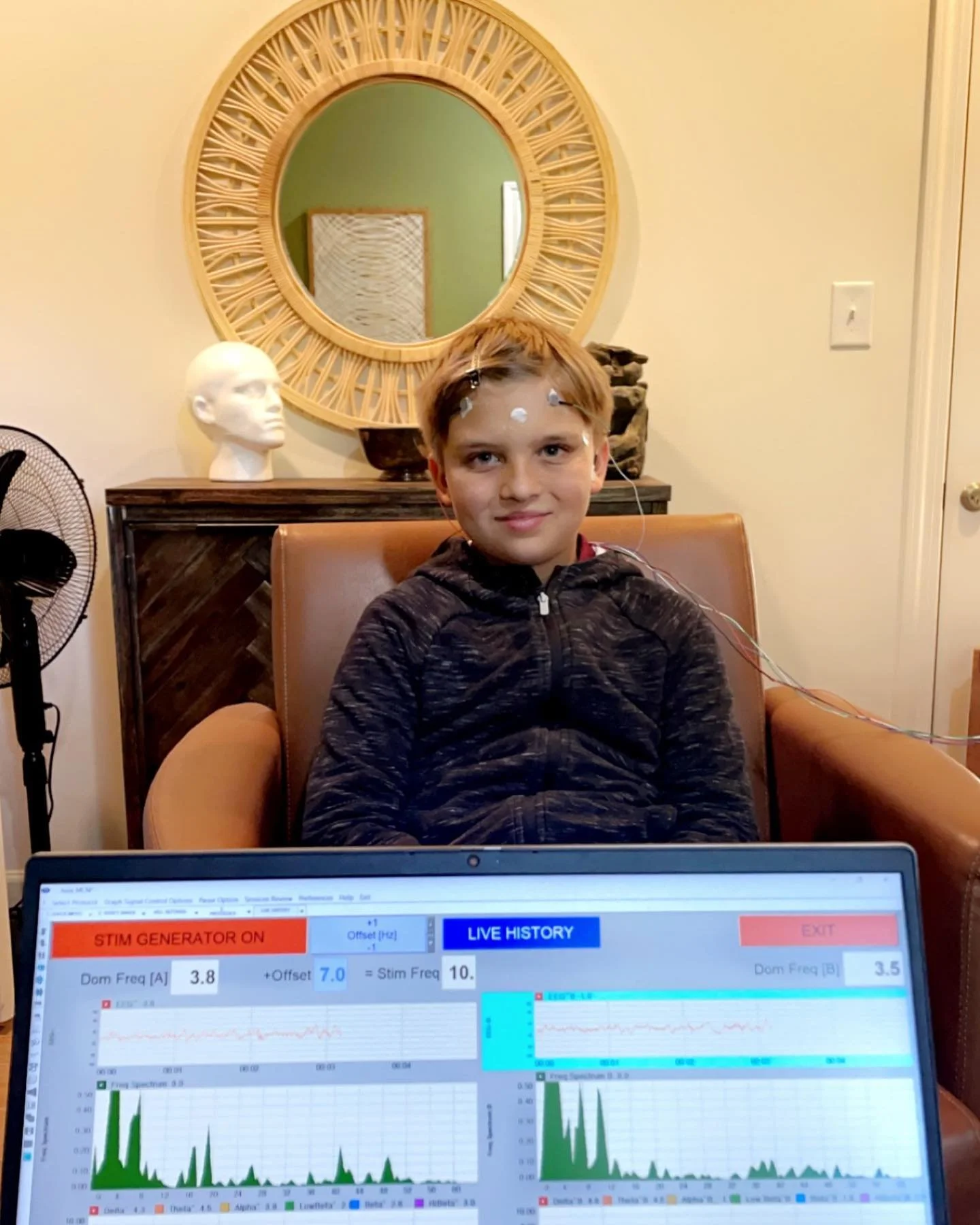 A child in the middle of a Microcurrent Neurofeedback session.