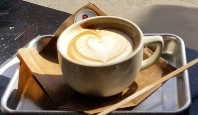 A latte with a heart made from the foam.