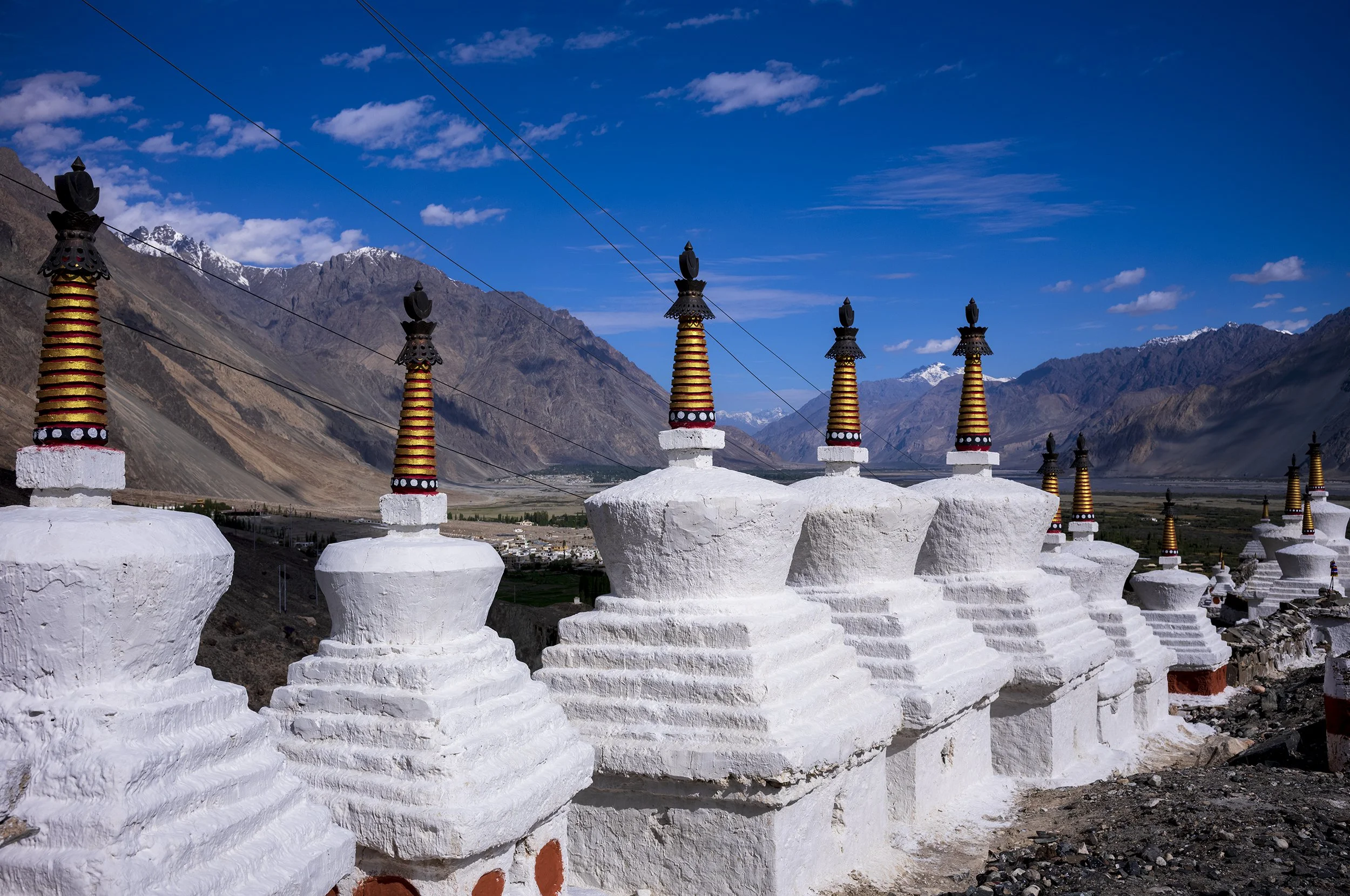Stupas (locally called chortens) at Diskit Monastery.  They function as sacred monuments for worship, spiritual protection, and the purification of negative karma