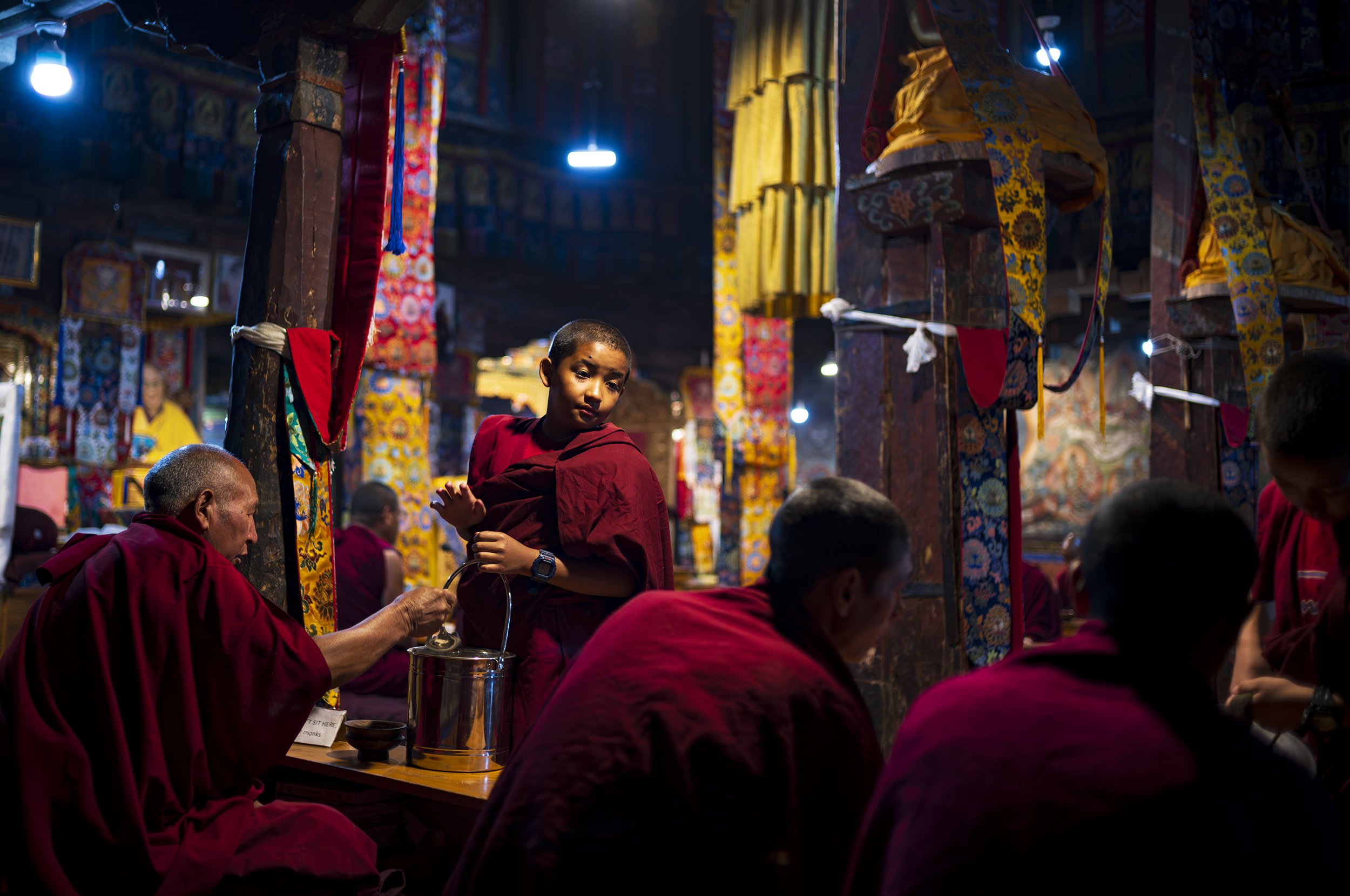 A comment is made amongst the monks that appears to irk the novice whilst he serves Tsampa