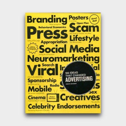 A yellow book cover titled "100 Ideas That Changed Advertising" by Simon Volesen. The cover features various words related to advertising in black bold text, including Branding, Scam, Press, Lifestyle, Social Media, Viral, Neuromarketing, Sponsorship, Mobile, Cinema, Celebrity, Endorsements, Search, Radio, Creative, Endorsement, and Appropriation.