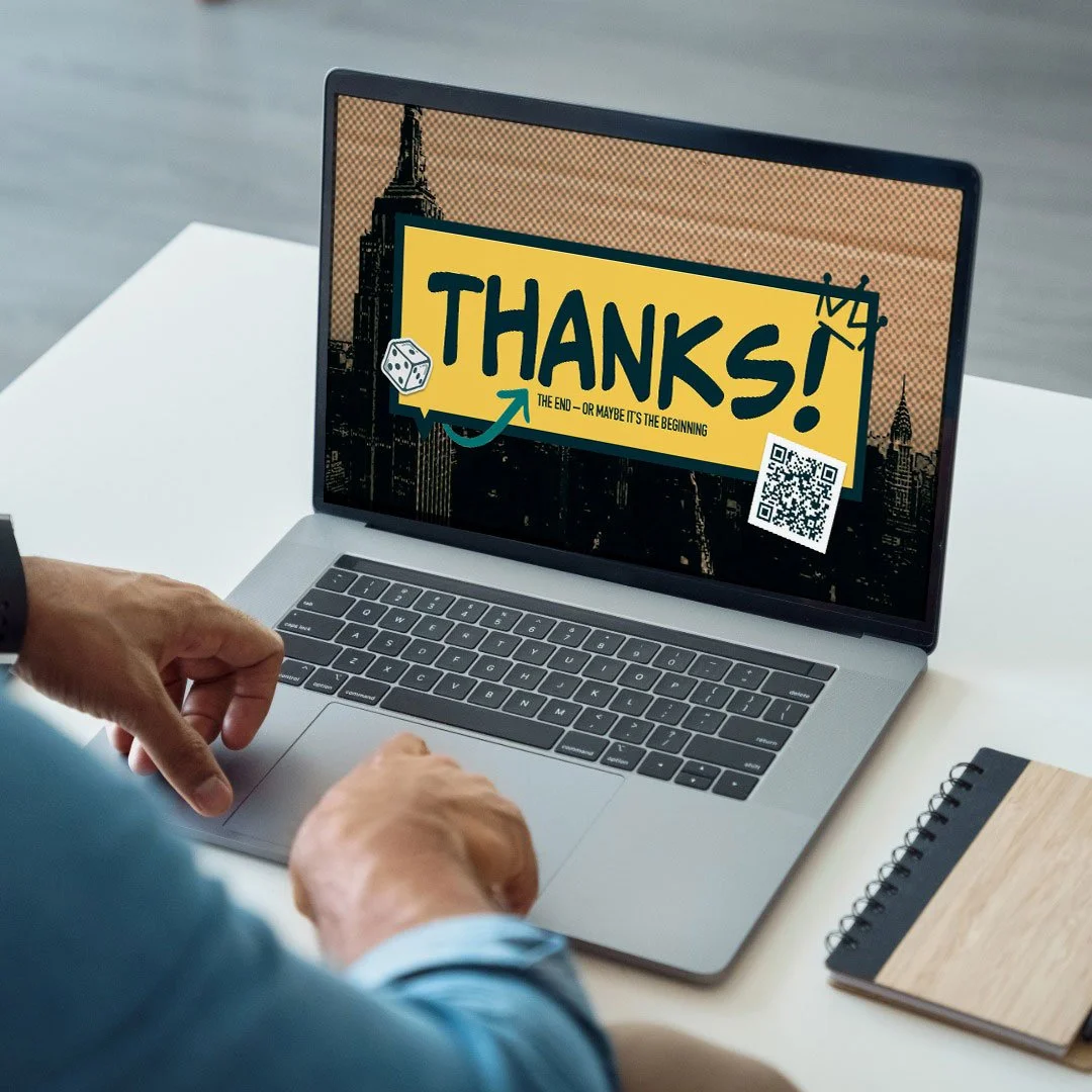 A person in a suit using a laptop on a white table, with a notepad nearby. The laptop screen displays a thank you message with a yellow background, black text saying 'THANKS!', a small dice icon, a QR code, and a background image of city buildings, i