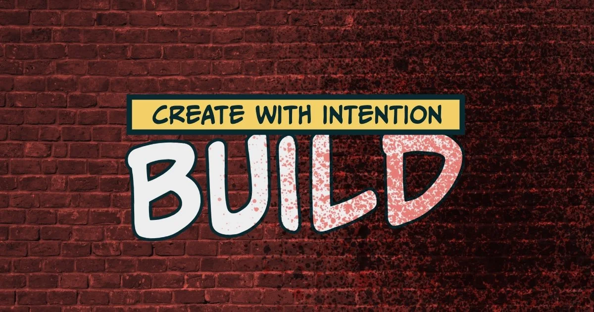 Wall art with the phrase "Create with Intent, Build" on a brick background, with a yellow banner and black text.