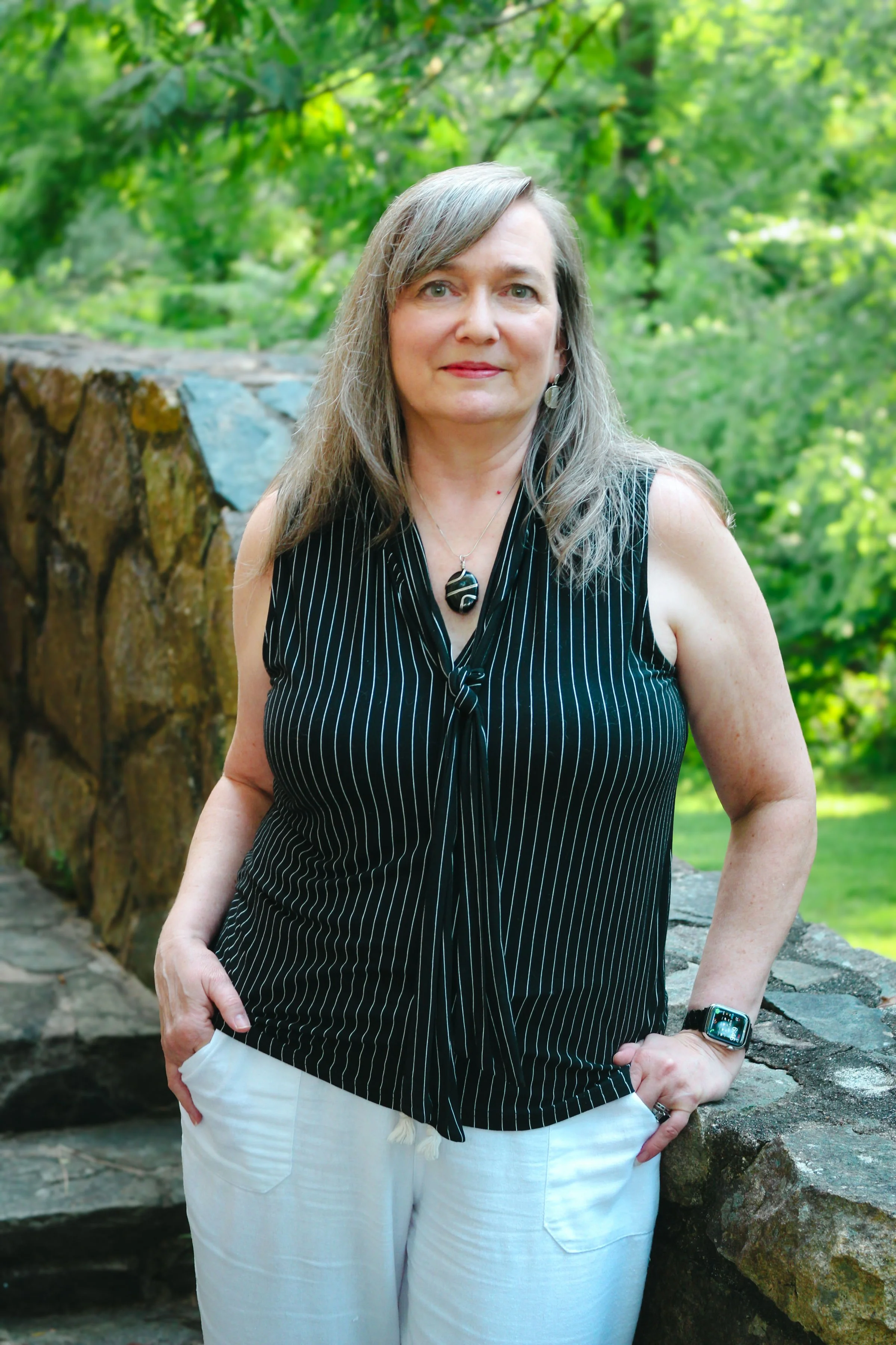 Beth Hovis, iridology and holistic wellness educator and business foundations mentor, standing outdoors.