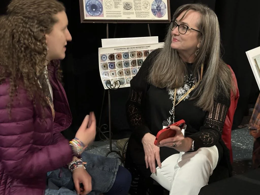 Beth Hovis sharing iridology with a participant at an educational booth during the Barbara O’Neill Self Heal Event.