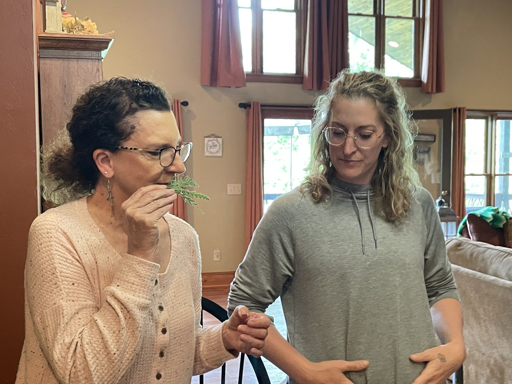 Students smelling herbs to learn their properties during the Brilliant Health Weekend Away Herbal Bootcamp.