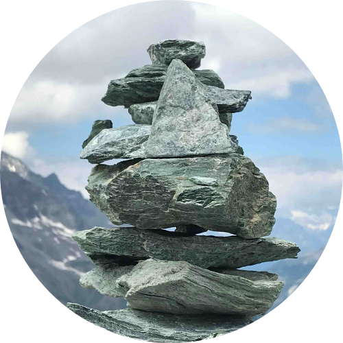Rocks stacked with a sky and clouds in the background