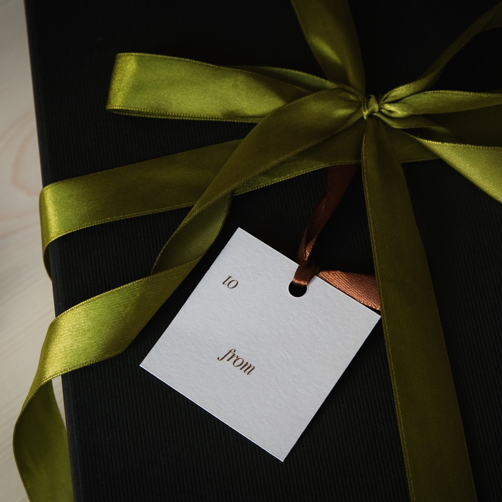 Wellness gift for her detail of gift tag and moss green ribbon