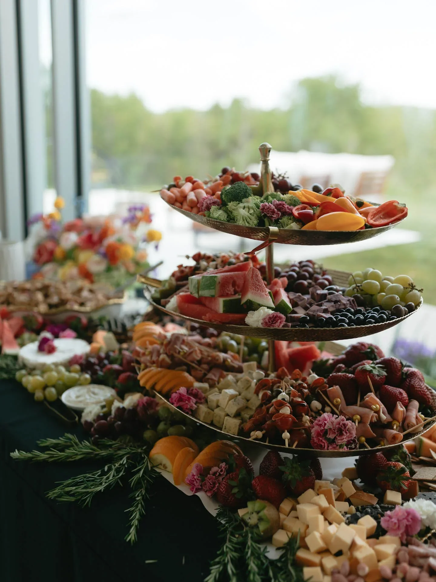 Gourmet grazing table featuring fresh fruit, cheese, and charcuterie