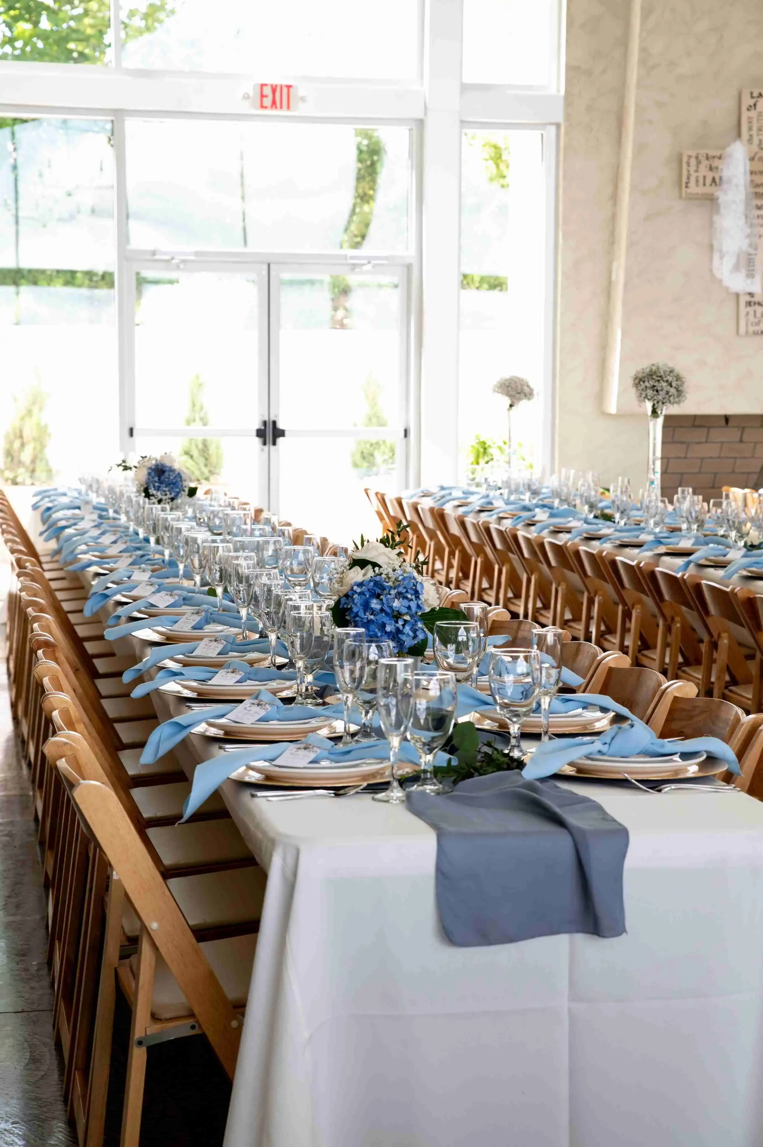 Elegant banquet reception setup with long tables and natural light