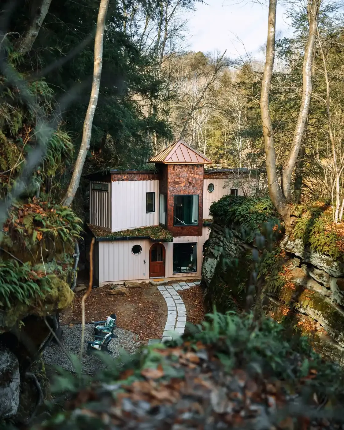 Unique multi-story Box Hop cabin nestled among trees and rock formations for on-site lodging