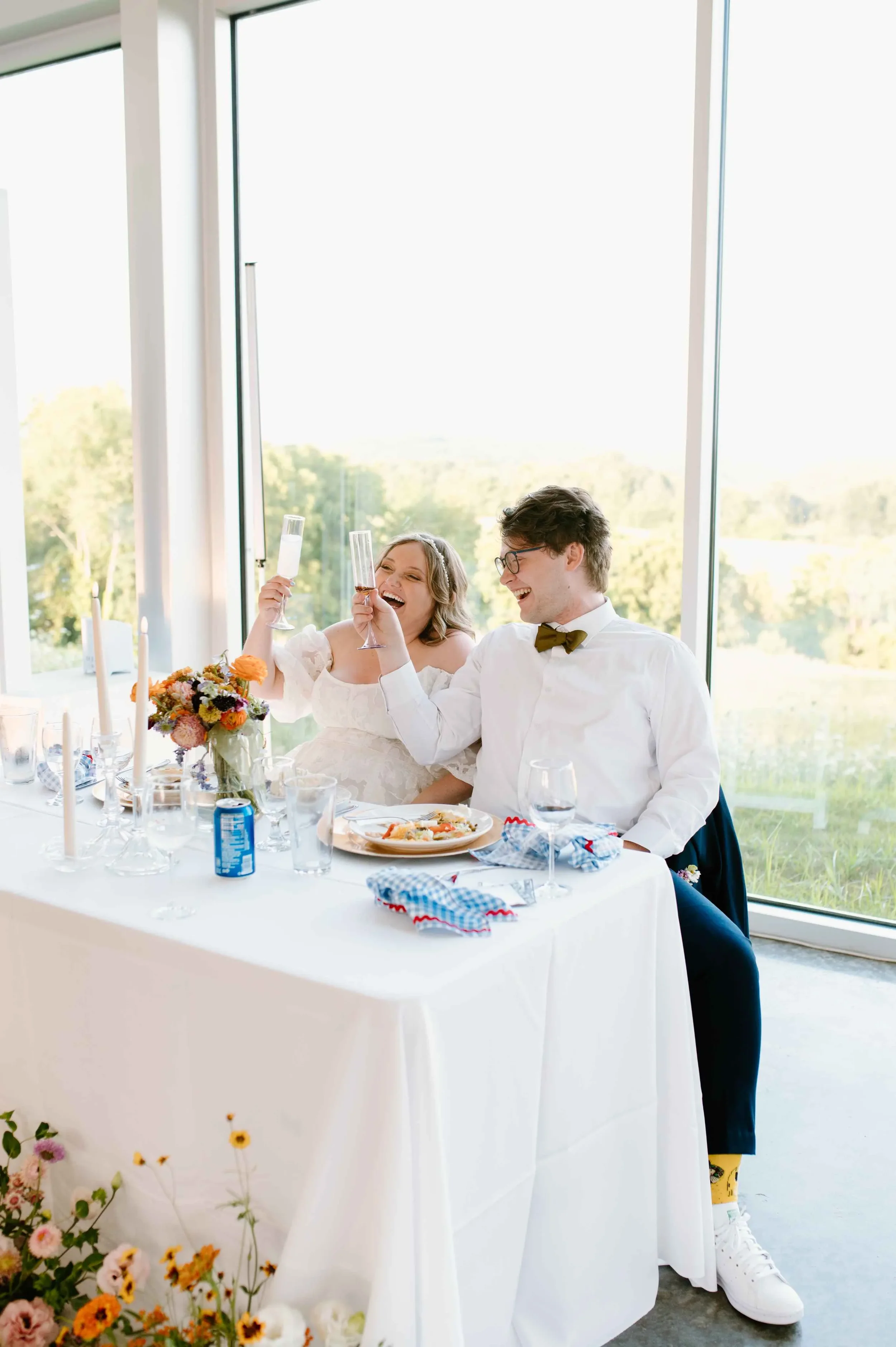 Newlyweds celebrating at reception sweetheart table
