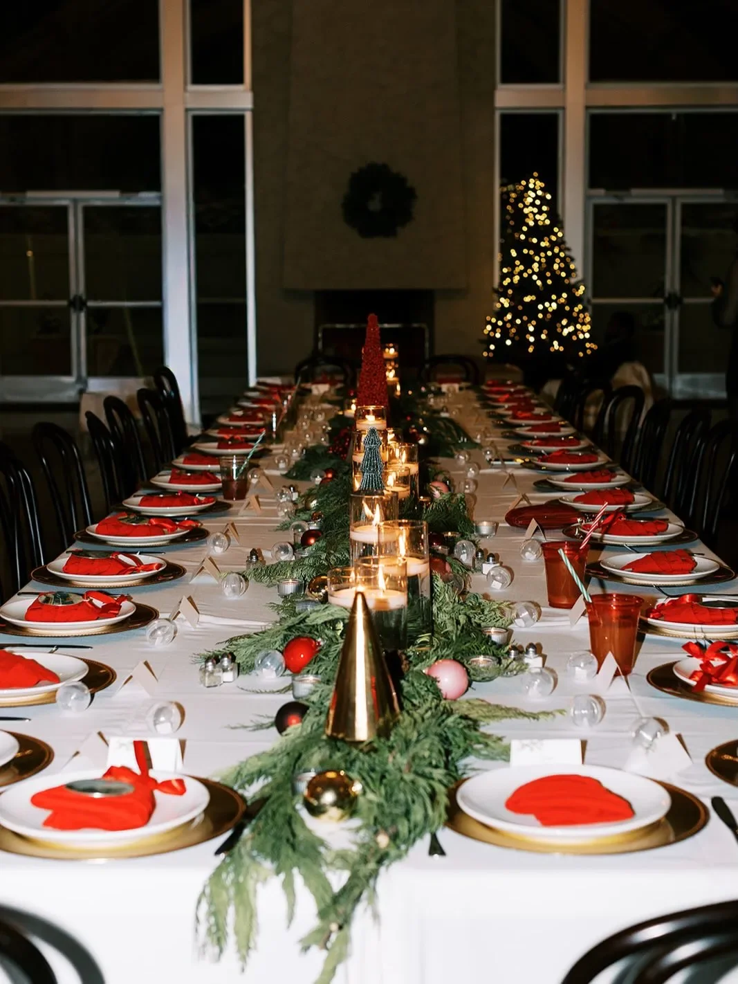 Holiday event tablescape with festive décor and candlelit centerpieces