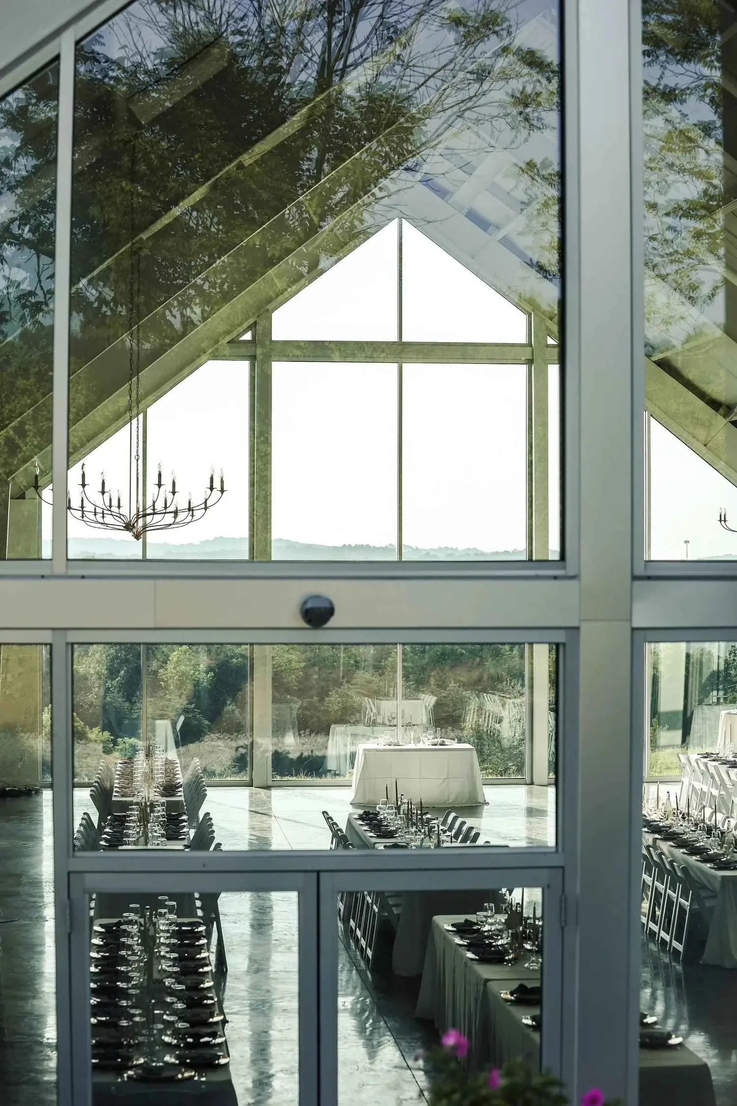 Reception setup inside modern glass wedding venue
