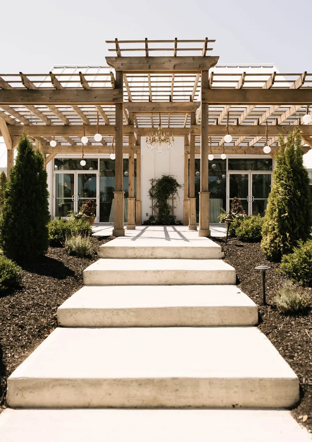Pergola-covered outdoor terrace for ceremonies and cocktail hours