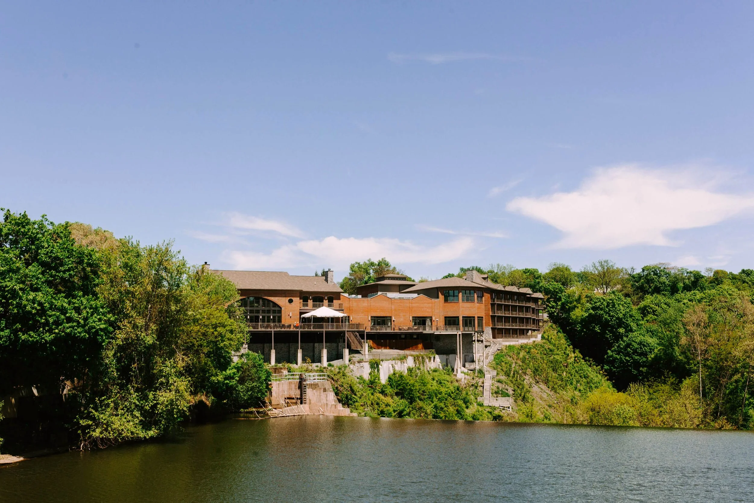 Diamond Mills exterior view over the water and Esopus Waterfall in Saugerties, NY