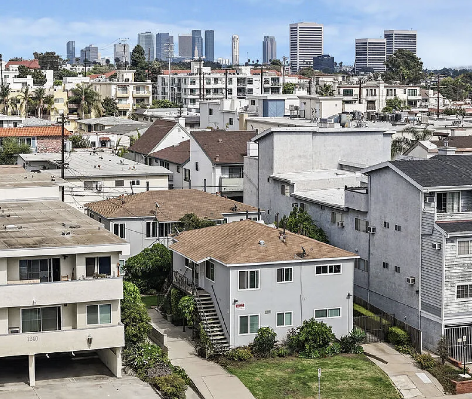 aerial of apartment building with century city skyline in background