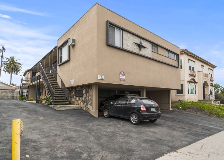 mid century apartment building with tuck under parking area