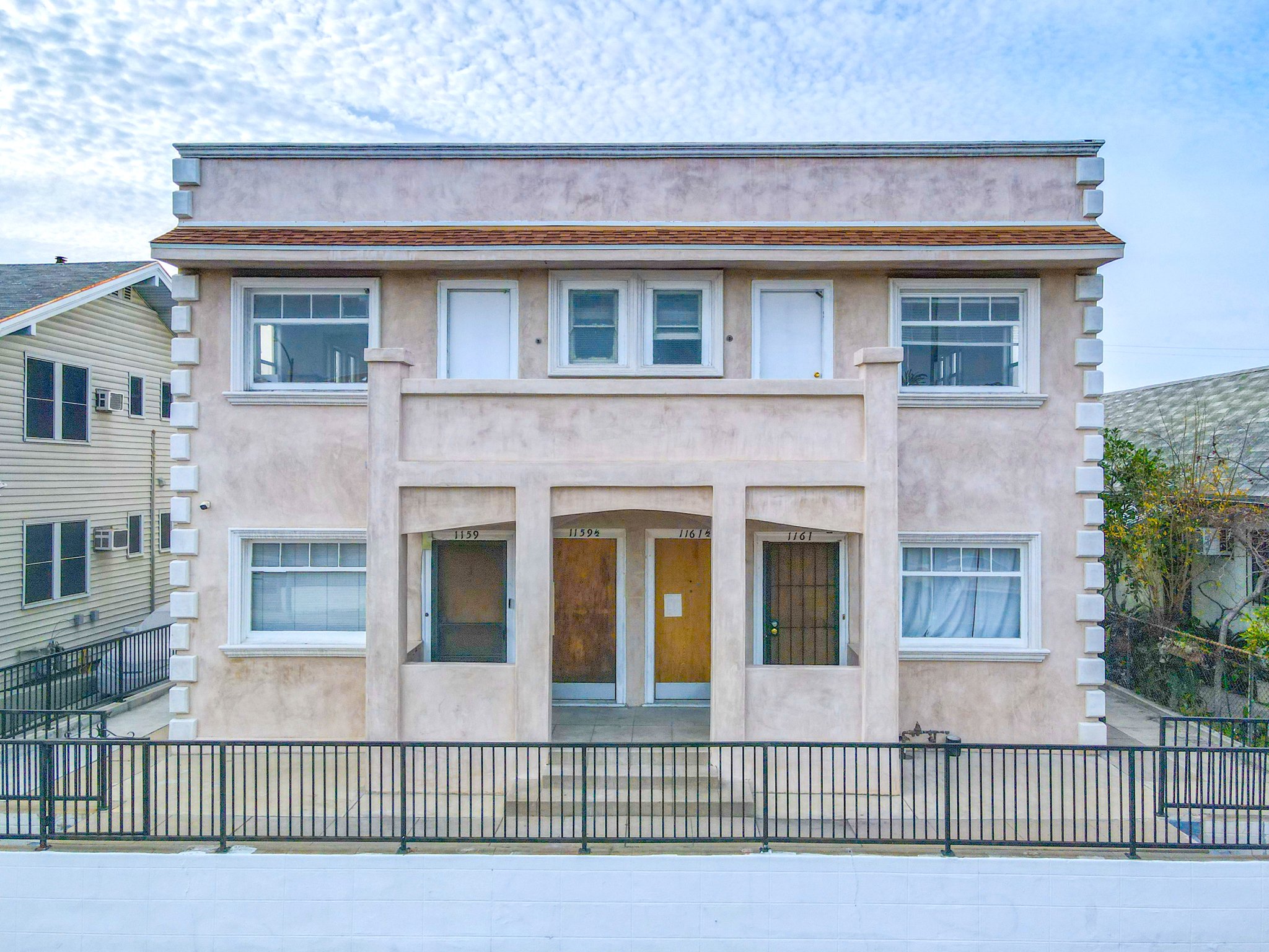 1920s stucco apartment building from street