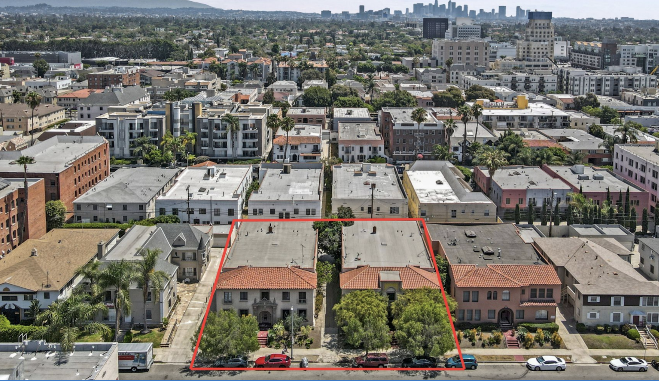 two spanish style apartment buildings aerial view with red border