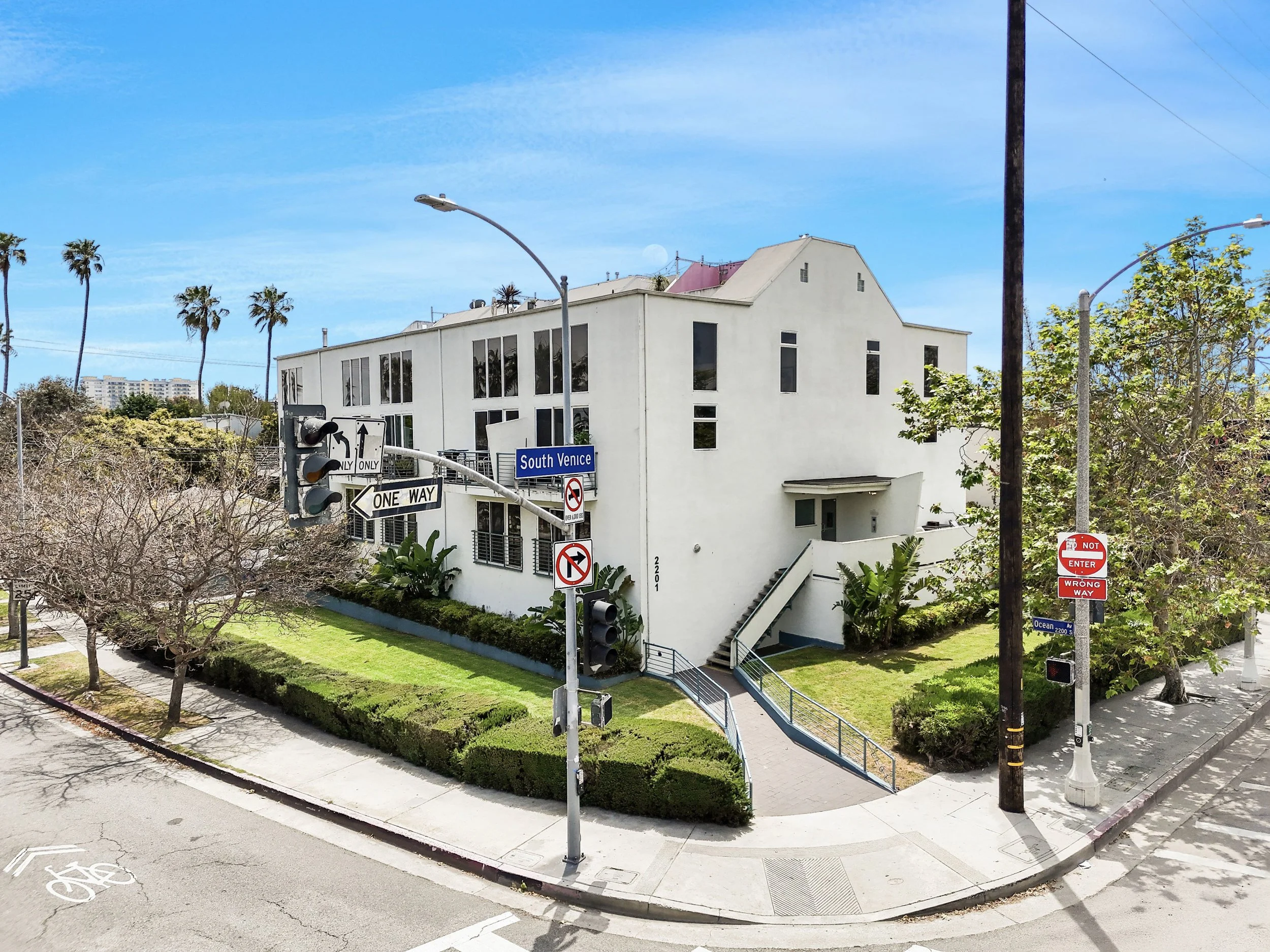white apartment building in venice beach on corner lot