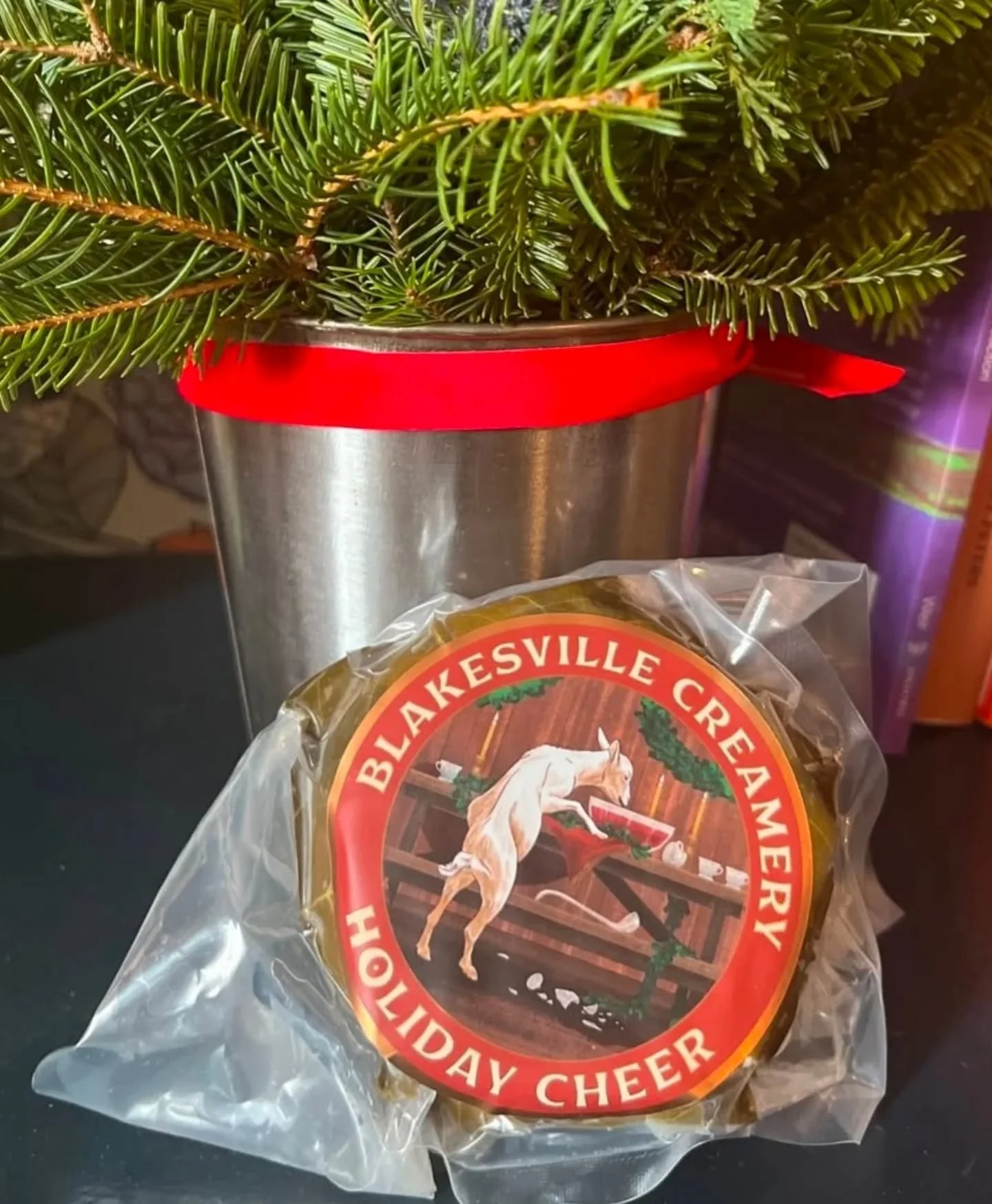 Add some cheer to your holiday spread with 𝙃𝙤𝙡𝙞𝙙𝙖𝙮 𝘾𝙝𝙚𝙚𝙧 from @blakesvillecreamery in Wisconsin. This fresh goat&rsquo;s milk cheese is flecked with orange and wrapped in Sakura cherry leaves soaked in cherry brandy, reminiscent of a booz
