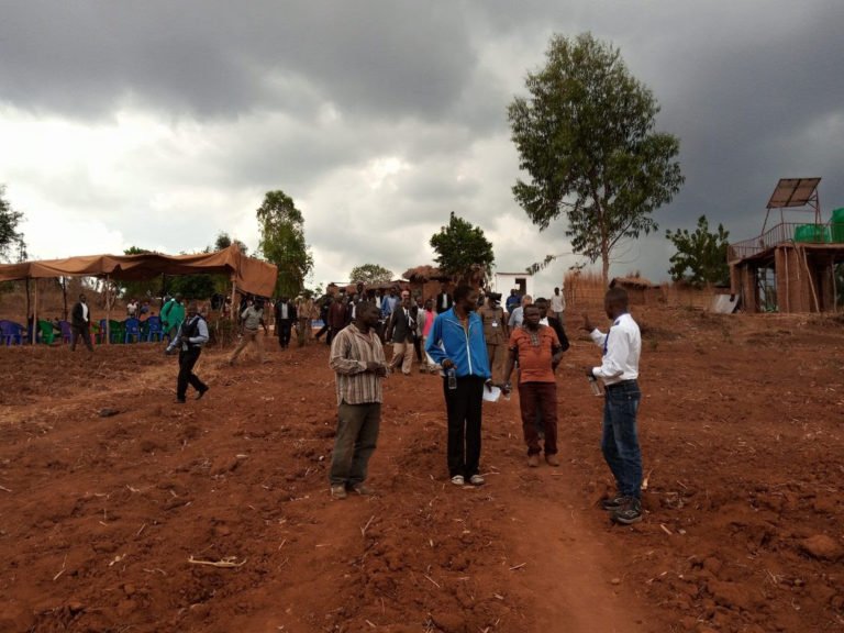   Moses Chirusha, MB Malawi communications officer (right), speaks with the Traditional Authority Njolomole and his two subordinates at an event launching a new project in 2021. The Ntcheu district of central Malawi is one of the locations for MB Mal