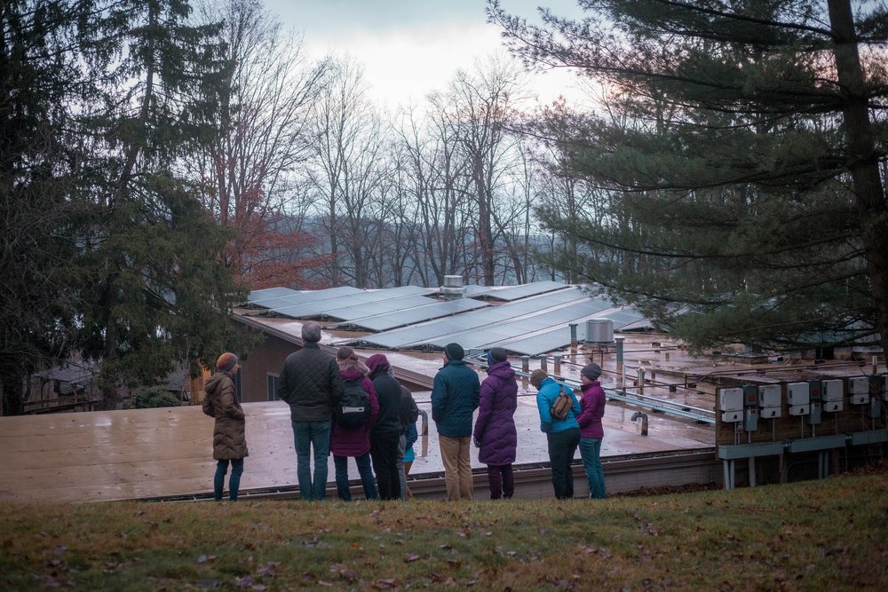  A group views the solar panels installed on the roof of the dining hall at Camp Friedenswald. 