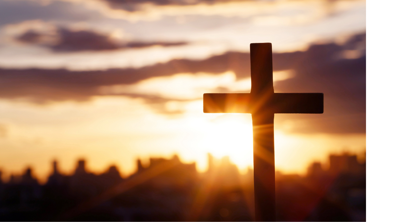 A cross is silhouetted against a sunrise