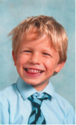 Pastor James Sholl as a young child, posing for a school photo.