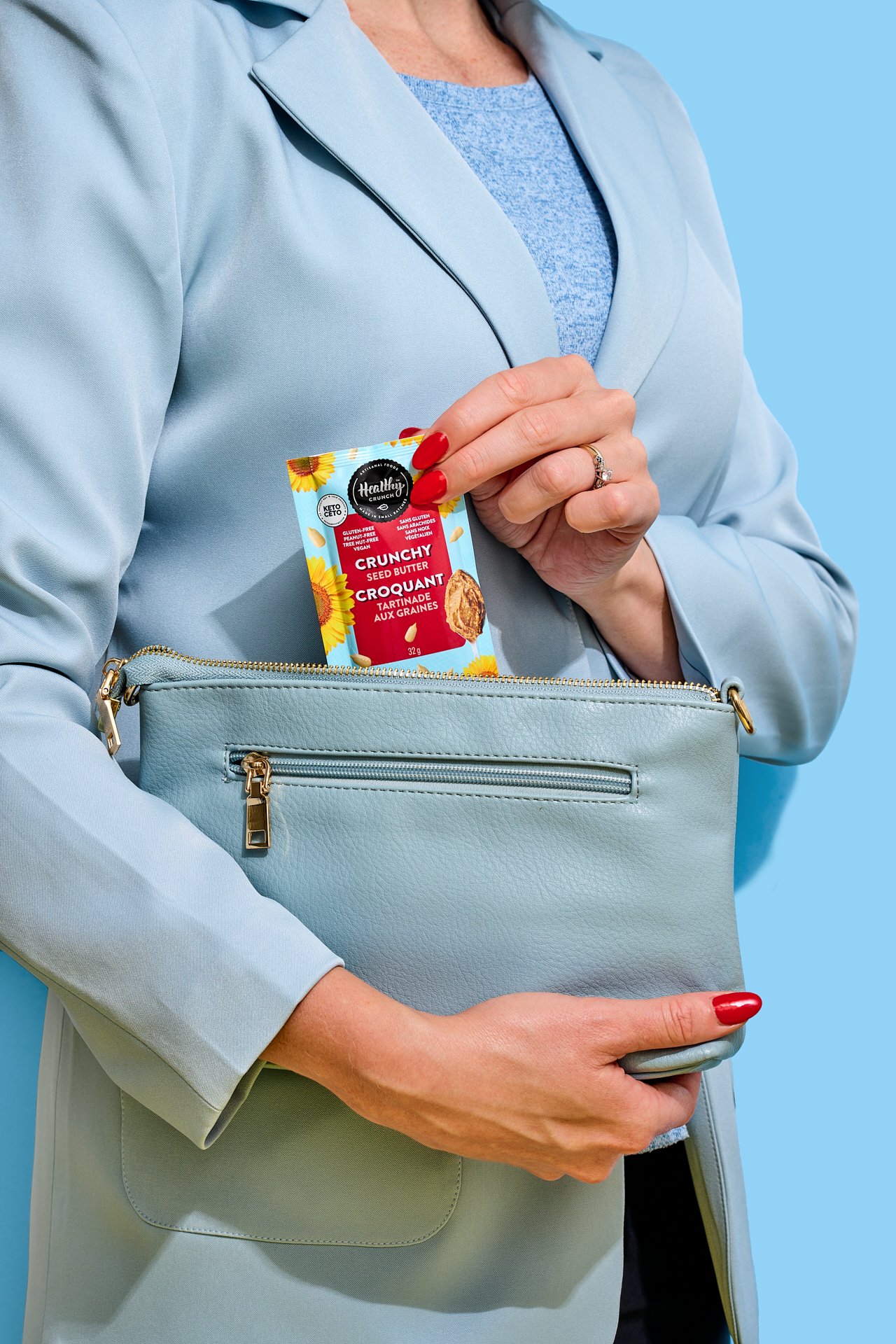 a model pulling a snack out of purse
