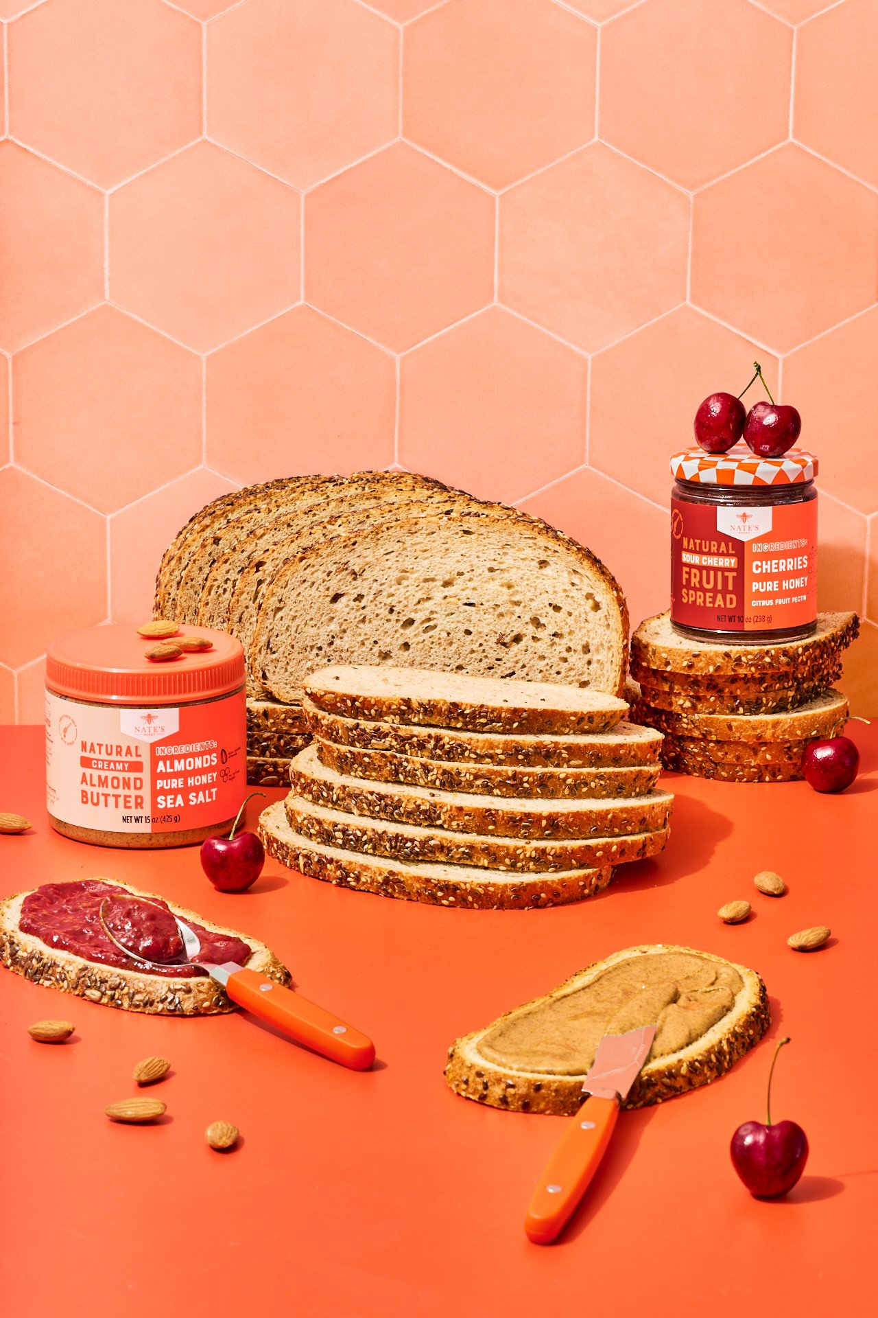Commercial food photography of toast topped with nate's honey cherry fruit spread and almond butter and fresh berries.
