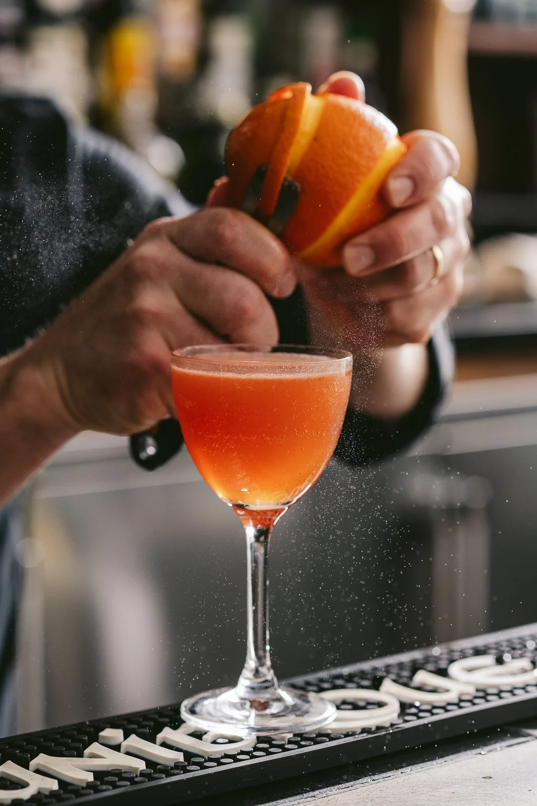 mixologist making a cocktail at the restaurant bar