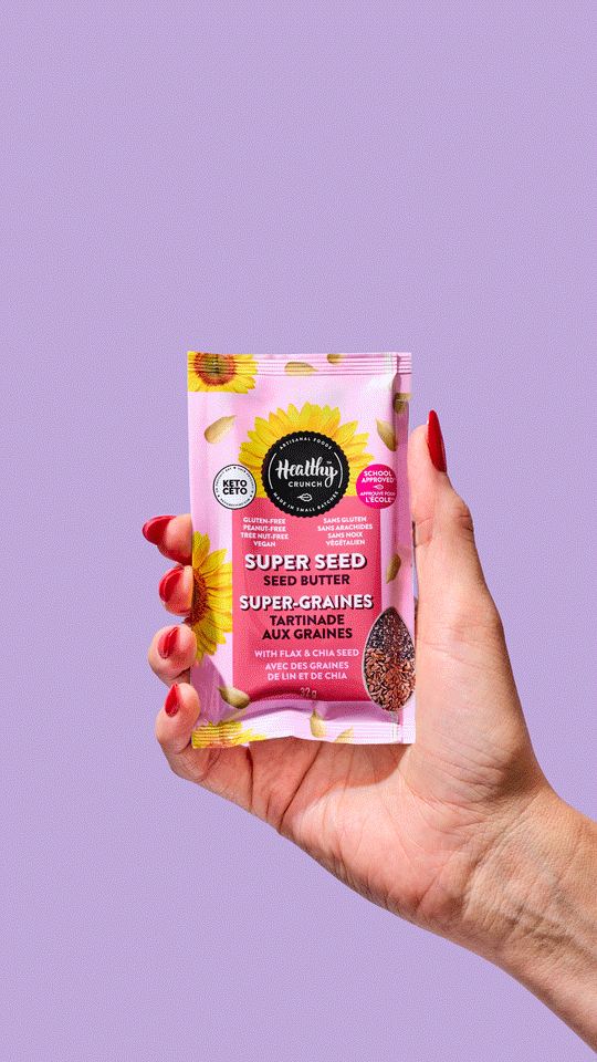 a stop motion of a hand holding healthy crunch's line of individual seed butter packets against a vibrant, colorful, bold purple backdrop. the stop motion flips through each flavour, but the hand stays in the same spot