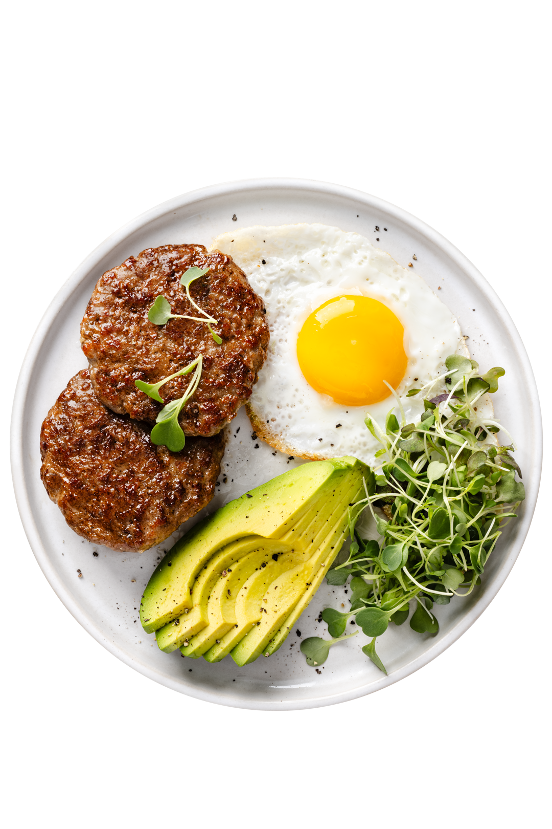 Plate with two cooked beef patties, a fried egg, sliced avocado, and microgreens.