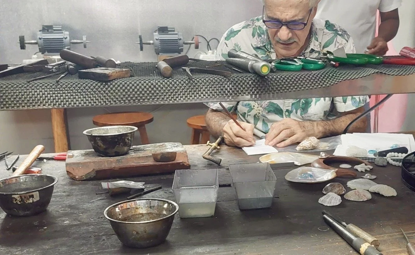 TASO jewelry designer working at his atelier surrounded by tools, shells and natural materials.