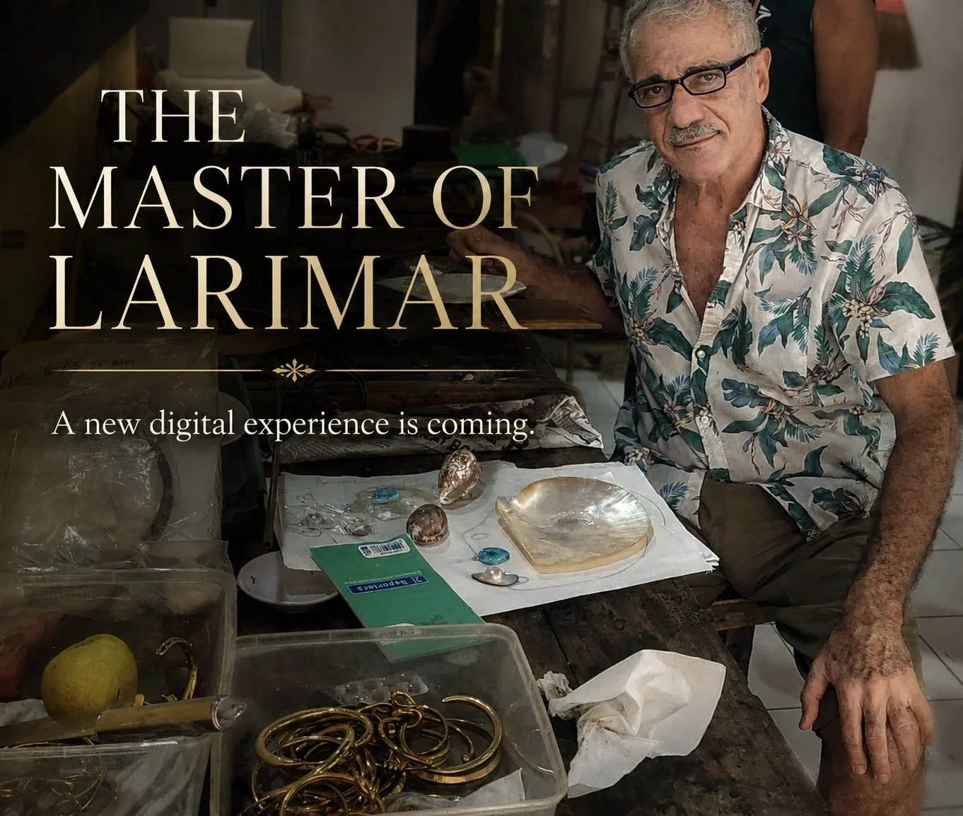 TASO, The Master of Larimar, surrounded by his jewelry creations and design materials.