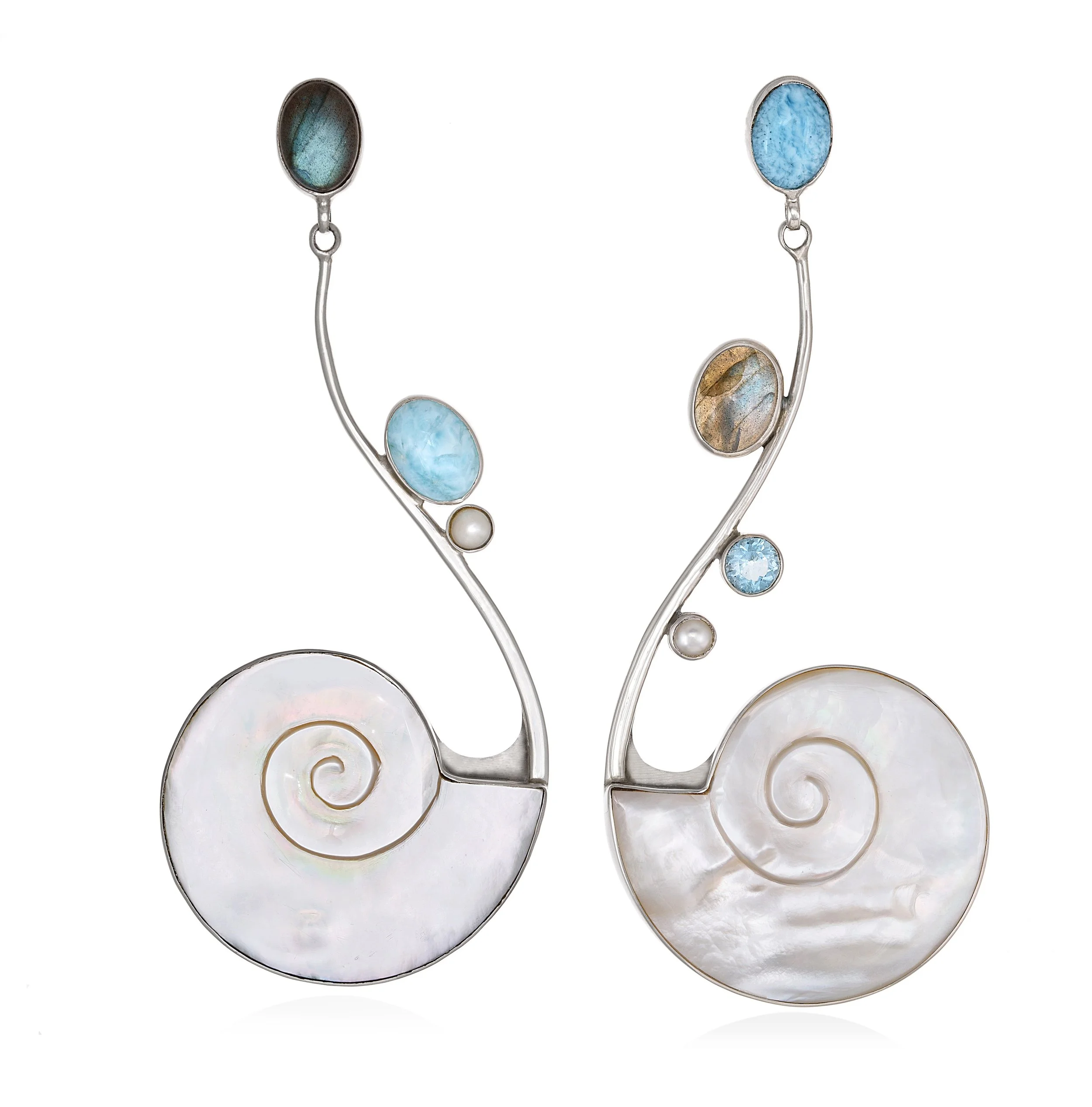 Original TASO jewelry design featuring sculptural silver forms with blue gemstones, created by jewelry designer Taso Haidemenakis.
