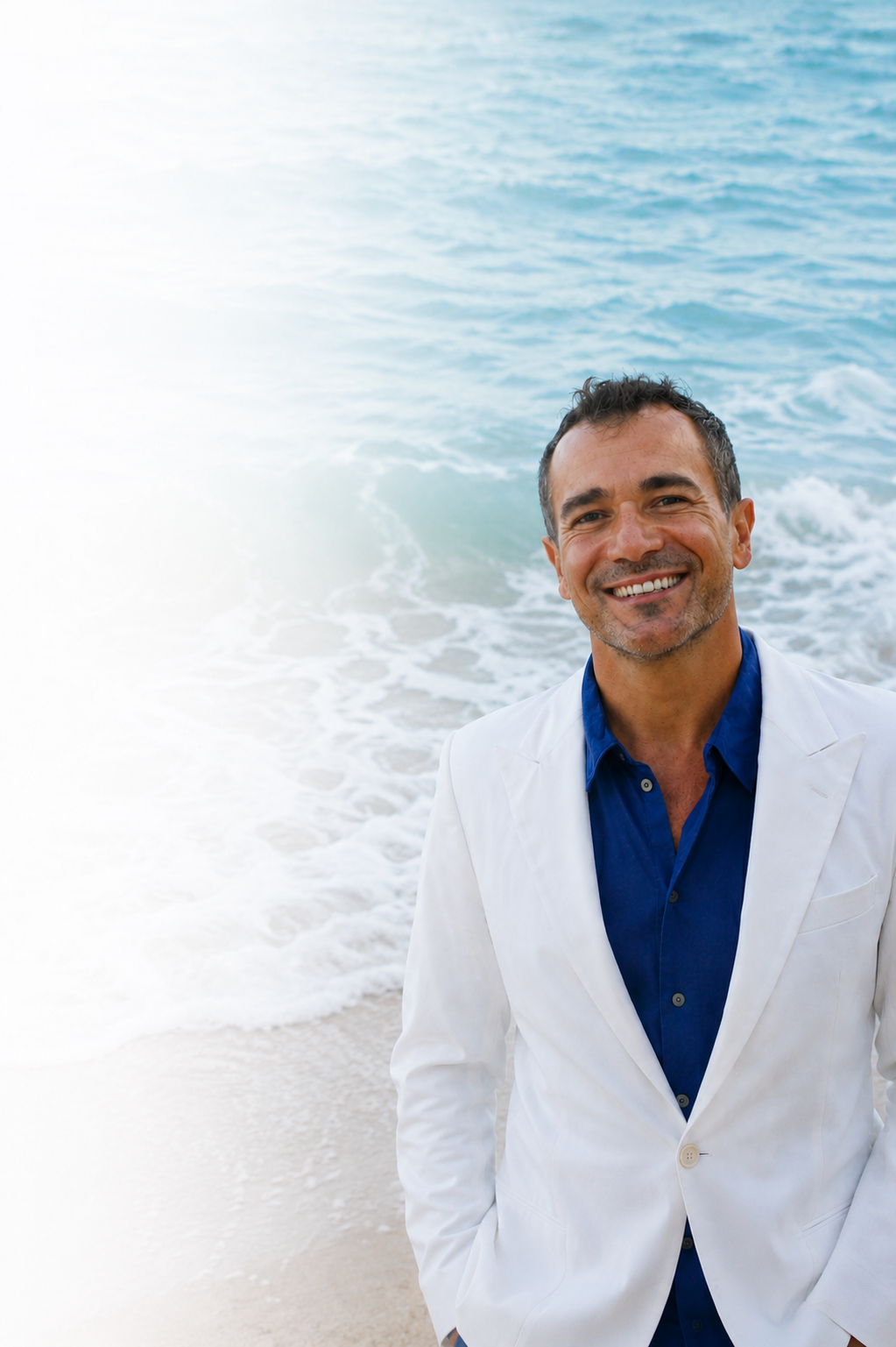 Jewelry designer Taso Haidemenakis by the Mediterranean Sea, reflecting the ocean inspiration behind TASO jewelry and Larimar creations.