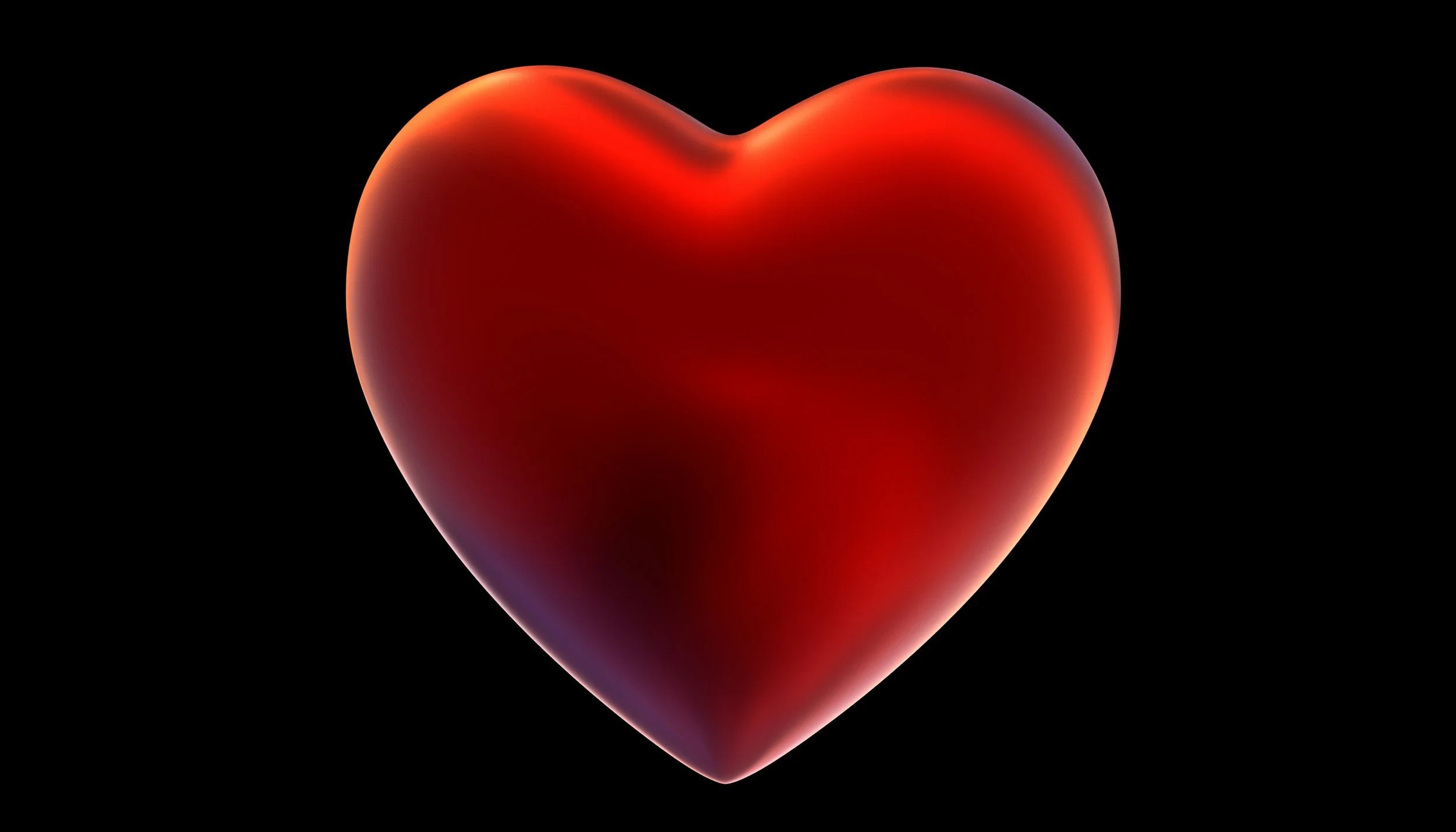 A shiny, red, three-dimensional heart against a black background.